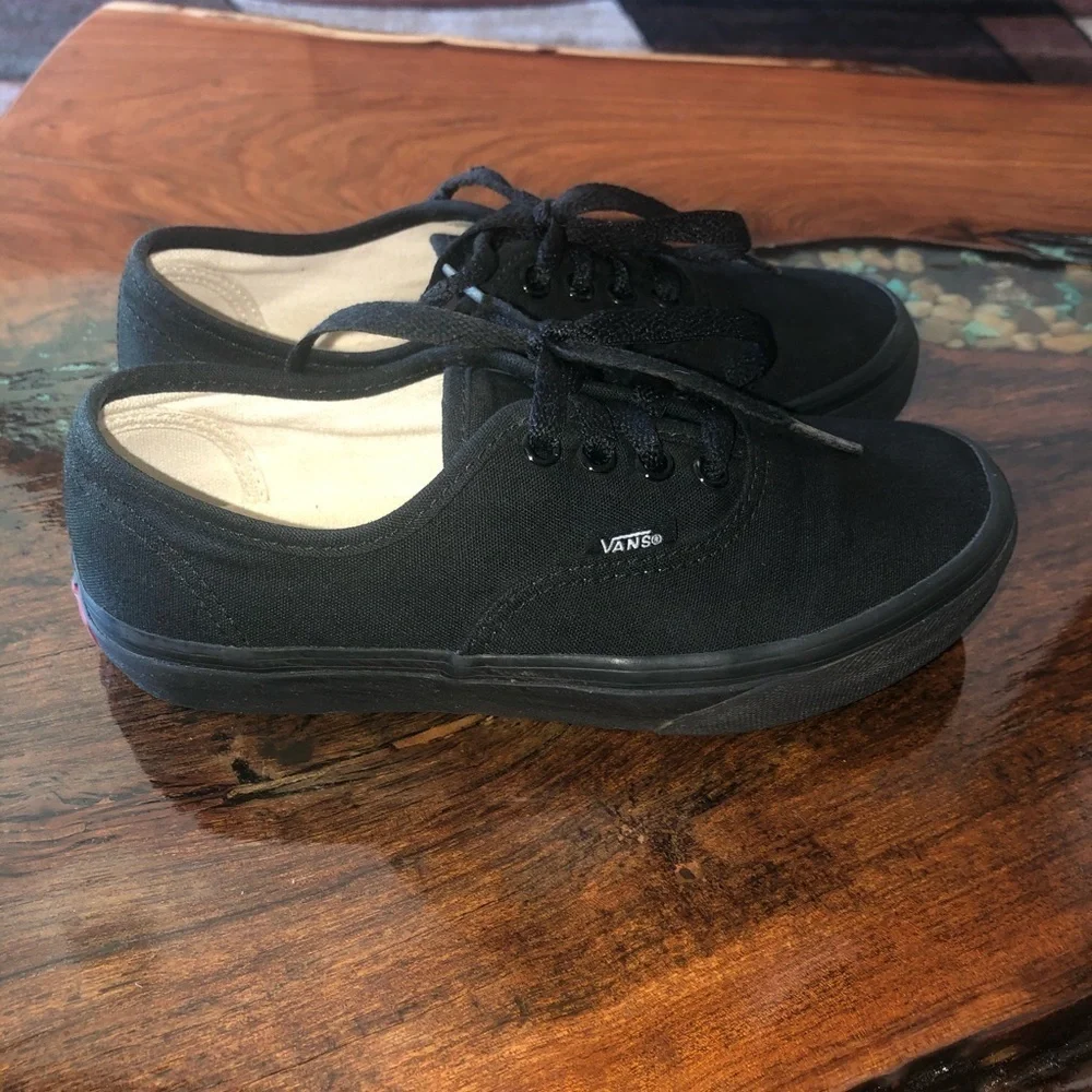 Vans all black kids lace up skateboard shoes.